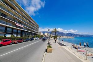 a city street with cars parked on the side of the road at French Riviera: Seafront apt & pool near Monaco in Roquebrune-Cap-Martin