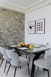 a dining room with a black table and chairs at Into the Jacuzzi by HolyGuest in Tel Aviv