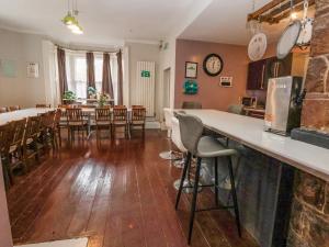 a kitchen and dining room with a counter and chairs at Ship Inn in Old Colwyn