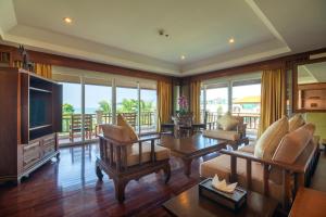 a living room filled with furniture and a tv at Avalon Beach Resort in Pattaya South