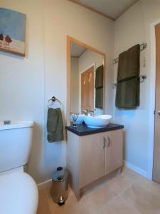 a bathroom with a sink and a mirror at Sycamore Lodge Auchterarder in Auchterarder