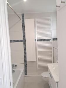 uma casa de banho branca com uma banheira e um WC em Paris chatou brand new quiet cosy flat em Chatou