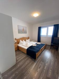 ein Schlafzimmer mit einem großen Bett mit einer blauen Decke in der Unterkunft Lungau Living Appartements - Penthouse in Sankt Michael im Lungau