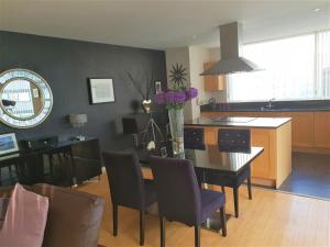 a kitchen and dining room with a table and chairs at Luxury Apartment Best location in Liverpool city center in Liverpool