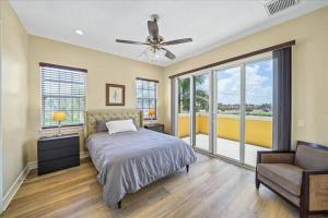 a bedroom with a bed and a ceiling fan at Beachside, 5 Bedroom Exclusive Home in Indian Harbour Beach