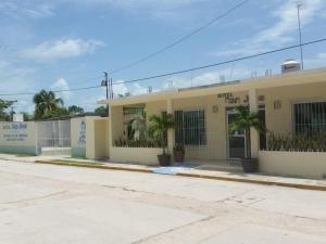 a yellow building with palm trees in front of it at HOTEL SAN JOSE in San Andrés