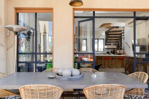 a dining room with a table and chairs at Fabulous Shark By HolyGuest in Tel Aviv