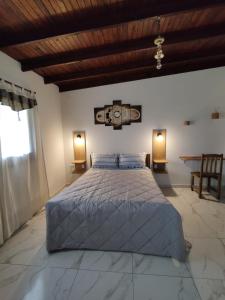 a bedroom with a large bed and a wooden ceiling at Bahía de cimarrones in Dolores