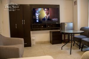 a living room with a tv and a table at Plaza Mayor Lima in Lima