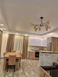 a kitchen and dining room with a table and a ceiling at Wonder Hill group in Bakuriani
