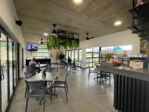 a restaurant with tables and chairs and a bar at Ballito 134 in Ballito