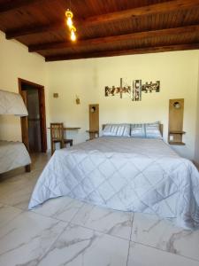 a bedroom with a large bed and a wooden ceiling at Bahía de cimarrones in Dolores