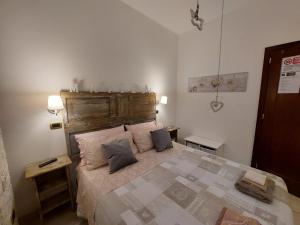 a bedroom with a large bed with two pillows at Mama Damì in Maruggio