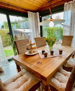 a wooden table in a dining room with chairs at 1000qm, Westerwälder Landhaustraum 