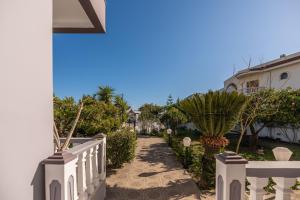 a pathway leading to a house with a cross on the side at Casa Stergos 2apts in Archangelos