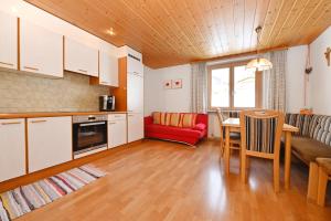 a kitchen and living room with a table and a couch at Haus Valuga in Bürserberg