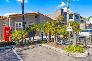 a house with palm trees in a parking lot at Pacific Plaza Resort Unit 108 in Oceano