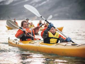 a woman and a child in a kayak on the water at Hotel Ullensvang in Lofthus