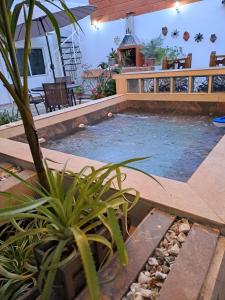 a swimming pool in a house with a patio at Villa Layla Santa Marta in Santa Marta