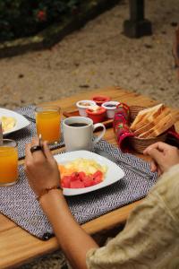 a person sitting at a table with a plate of food at Piedra de Agua Palenque in Palenque