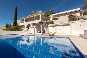 - une piscine en face d'une maison dans l'établissement Villa Melandrina, à Égine
