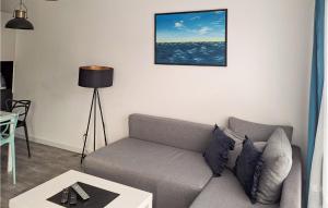 a living room with a couch and a table at Beautiful Apartment In Koszalin in Koszalin