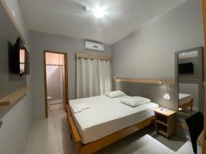 Postel nebo postele na pokoji v ubytování Kanoa Hotel