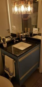 a bathroom with a sink and a mirror at Viva Sampa! in Sao Paulo