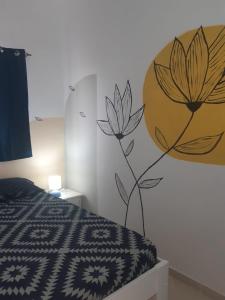 a bedroom with a flower mural on the wall at A.M.A Appartament in Calheta Do Maio
