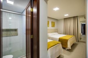 Postel nebo postele na pokoji v ubytování Hotel Encantos de Itaperapuã + 37 fotografií