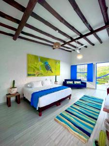 a bedroom with a large bed and a large rug at Hotel Parque la Casona in Garzón