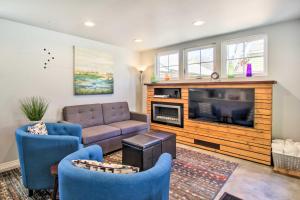 a living room with a couch and a fireplace at Fort Collins Vacation Rental with Private Hot Tub! in Fort Collins