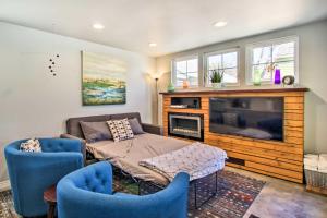 a living room with a couch and a tv at Fort Collins Vacation Rental with Private Hot Tub! in Fort Collins