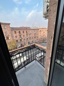 a balcony with a view of a building at Cozy apartment in Yerevan