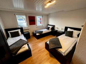 Cette petite chambre comprend deux lits et un canapé. dans l'établissement OhPardon! GAILDORF - DG Wohnung, Garten, Smart-TV, à Gaildorf