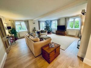 a living room with a couch and a table at Seaside Spacious Cosy Cottage On The Edge Of The New Forest in Lymington