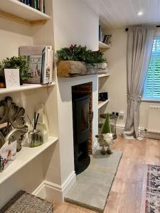 a living room with a fireplace with a christmas tree at Seaside Spacious Cosy Cottage On The Edge Of The New Forest in Lymington