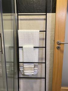 a towel rack with towels on it in a shower at Apartamentos Barbosa in Vila Nova de Foz Coa