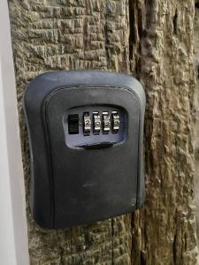 a soap dispenser on the side of a tree at Apartamentos Barbosa in Vila Nova de Foz Coa