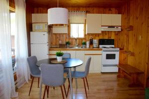 a kitchen with a table and chairs in a room at 1 and Only Riverside Accommodations in Sable River