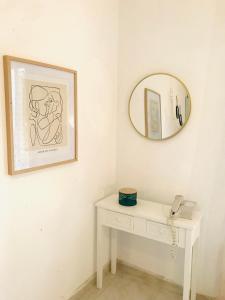 a bathroom with a white table and a mirror at Skopelos Inn in Stafylos