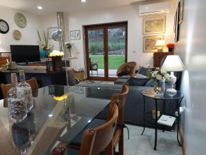 a living room with a glass table and a couch at Cottage, Casa do Laranjal - Near Gerês in Geres