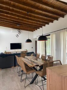 a dining room with a large wooden table and chairs at CASA ALQUILER PINAMAR in Pinamar