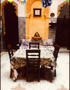a dining room table with chairs and a table and a couch at House Naïma in Rabat