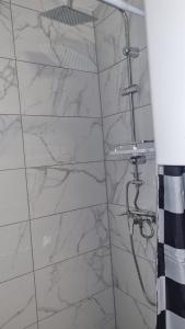a bathroom with a shower with white marble walls at Casa Rustica in Graz