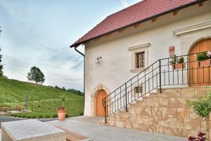 a white house with a staircase and a door at Hisa 1624 - Adults Only in Zgornja Kungota