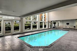 a large swimming pool with blue water in a building at Cityscape Dreams in Seattle