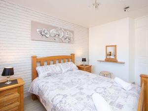 a bedroom with a bed and two tables and a mirror at Belfast City Apartment in Belfast