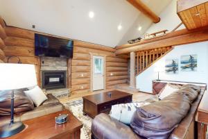 uma sala de estar com sofás de couro e uma lareira em Cole Point Castaway em Johnson Landing