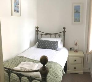 a bedroom with a bed with a black and white bedspread at Abbey Green, New Abbey, Dumfries and Galloway in Dumfries